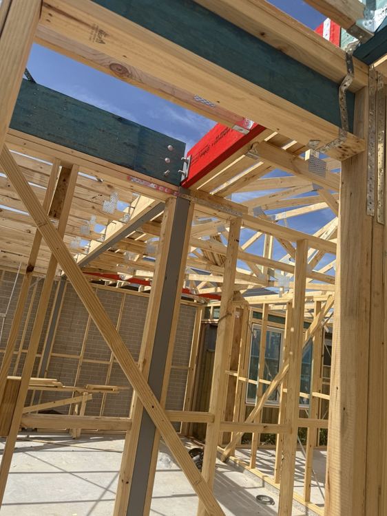 Beam supports and adjoining timber framing while connections remain visible.