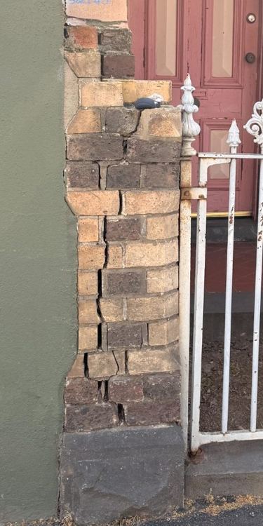 Existing vertical cracking to a brick masonry pier beside a gate