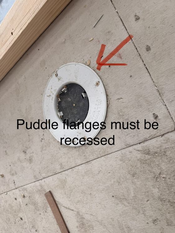 Floor-waste flange detail marked for attention before subsequent wet-area work.