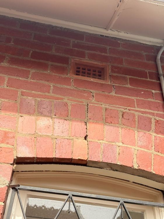 Cracking in brickwork above an arched opening
