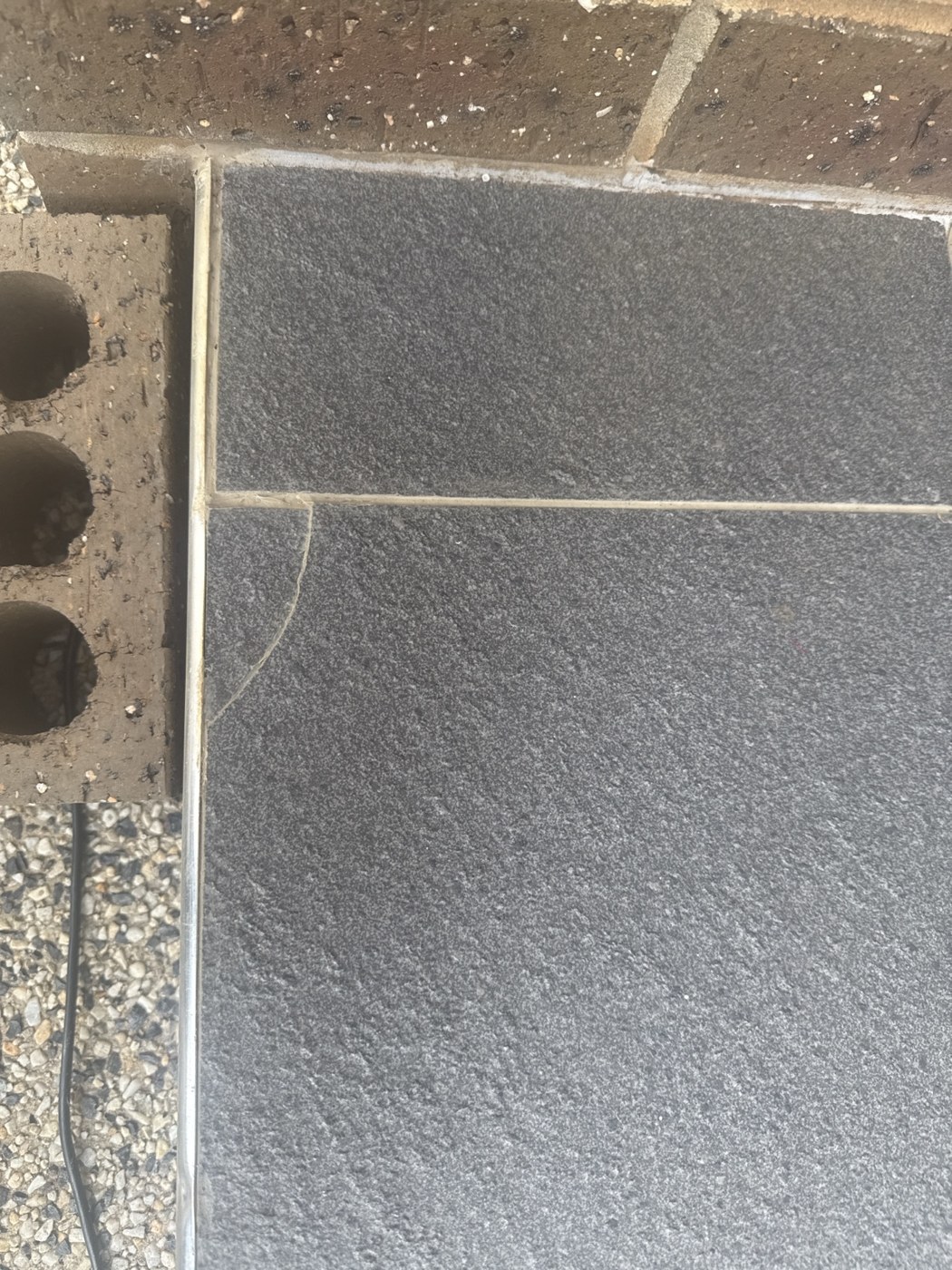 Close-up of a floor tile defect recorded at handover